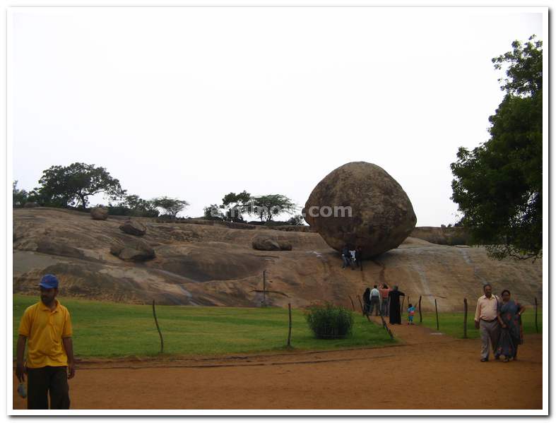 Visitors looking at the huge Krishna's butter Rock